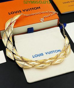 Gold leaf-designed necklace on Louis Vuitton display.