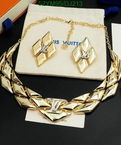 Luxury gold necklace and earrings set on display.