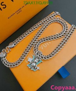 Luxury branded silver chain and charm on orange packaging.