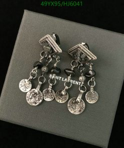 Saint Laurent silver charm earrings on gray background.