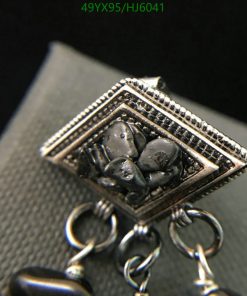 Close-up of intricate silver charm detail.