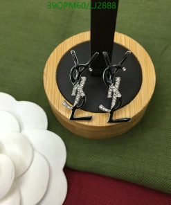 Earrings shaped like rhythmic gymnasts on display stand.