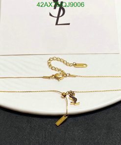 Gold necklace on white display with emblem.