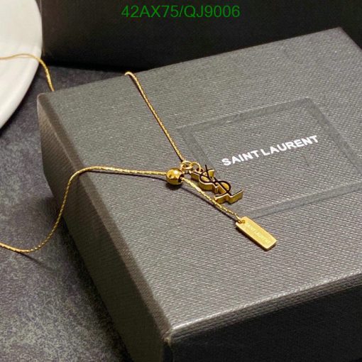 Gold necklace on Saint Laurent box.