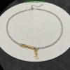 Elegant choker necklace with gold pendant on white display.