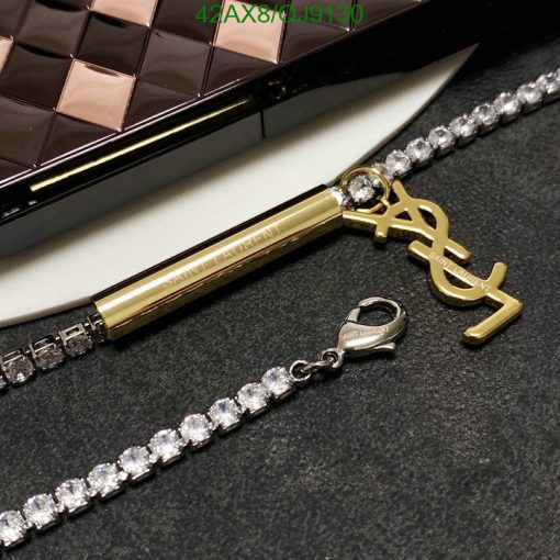 Designer clutch, pen, and diamond necklace.