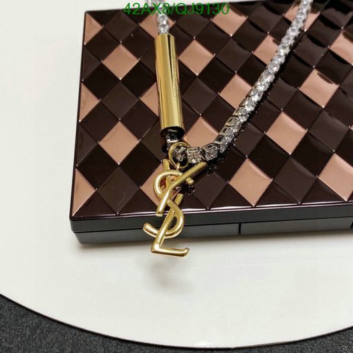 Designer handbag with chain and logo charm detail.