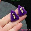 Purple triangle-shaped stud earrings.