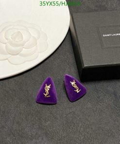 Saint Laurent earrings on display with box and plate.