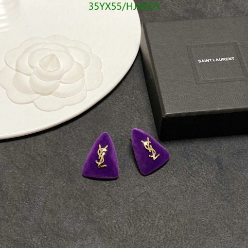 Saint Laurent earrings on display with box and plate.