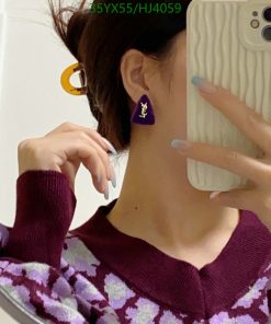 Person taking selfie showing earring and sweater.