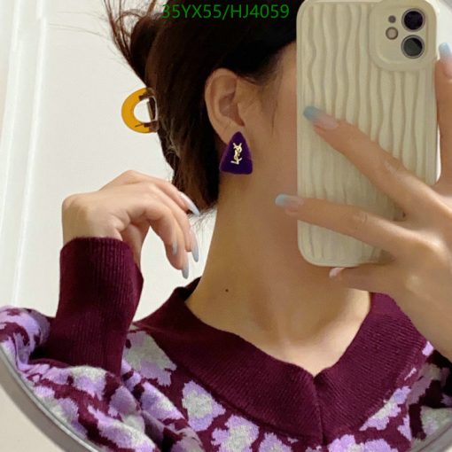 Person taking selfie showing earring and sweater.