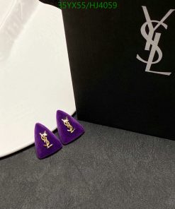 YSL logo earrings on velvet with brand packaging.