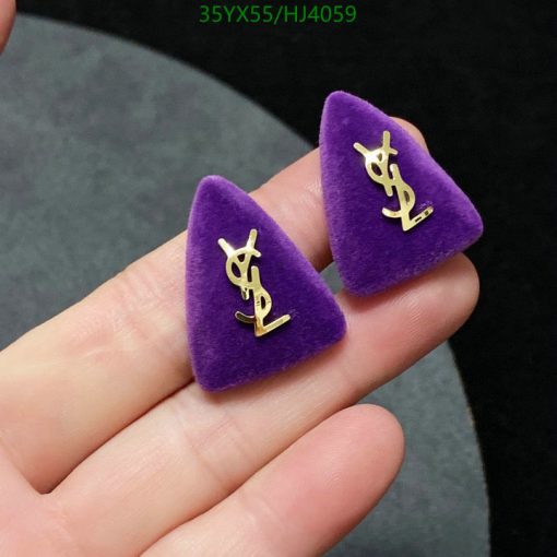 Purple triangle designer earrings in hand.