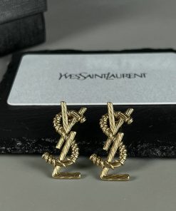 Gold designer cufflinks on display with box