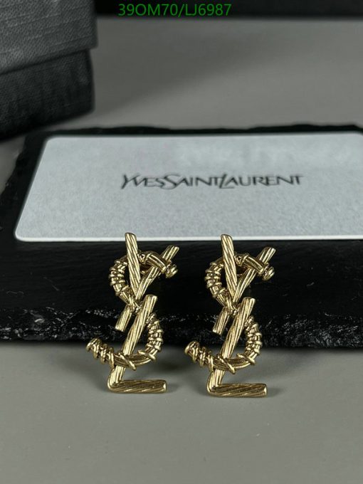 Gold designer cufflinks on display with box