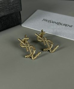 Gold designer cufflinks on display with box.