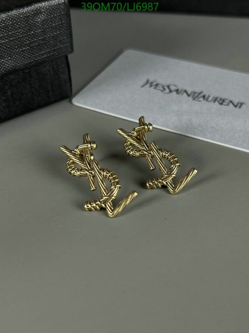 Gold designer cufflinks on display with box.