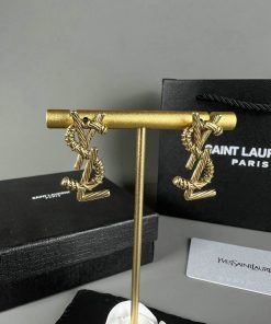 Designer gold cufflinks with packaging.