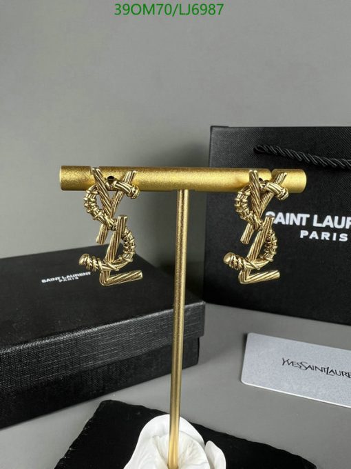 Designer gold cufflinks with packaging.