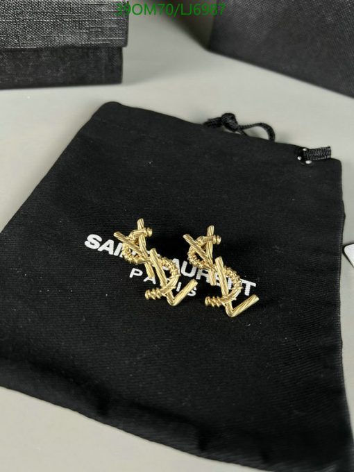 Gold cufflinks on black branded pouch.