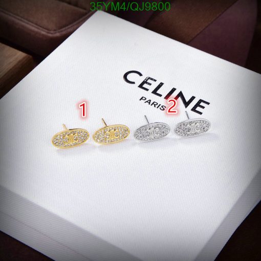 Celine branded earrings on white display.