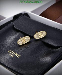 Gold designer cufflinks on black leather case.