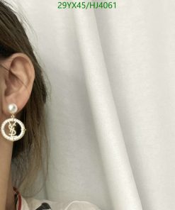 Woman showcasing pearl designer earring.