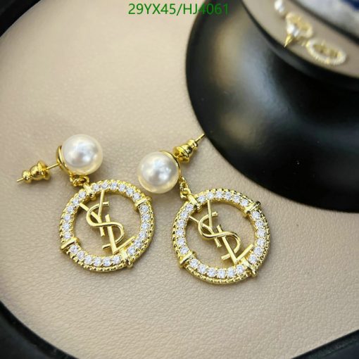 Gold dollar sign earrings with pearls and crystals.