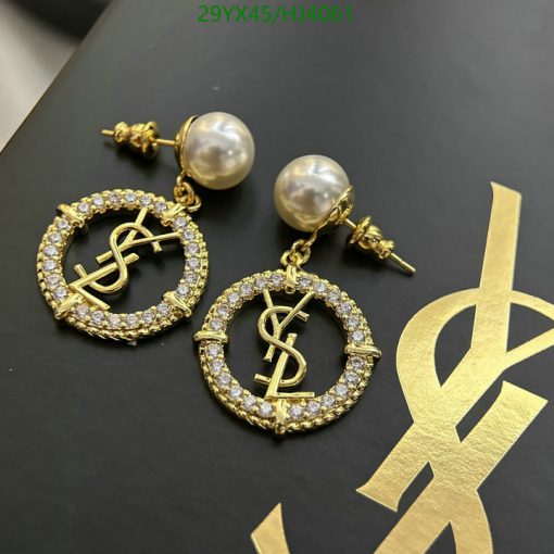 Designer pearl drop earrings with logo on black background.