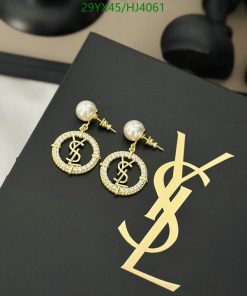 Luxury dollar sign pearl earrings on black.