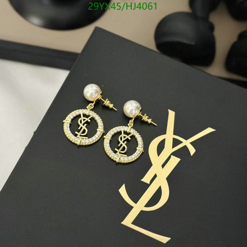 Luxury dollar sign pearl earrings on black.