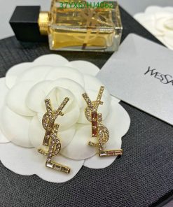 Crystal-embellished gold designer logo earrings.