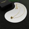 Gold pendant necklace on white display with box.