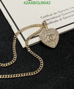 Gold heart-shaped pendant with logo on certificate.