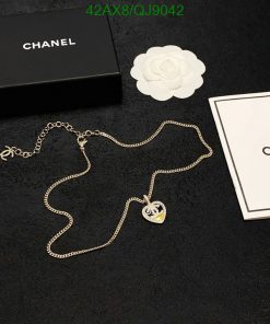 Designer necklace with packaging on black background.