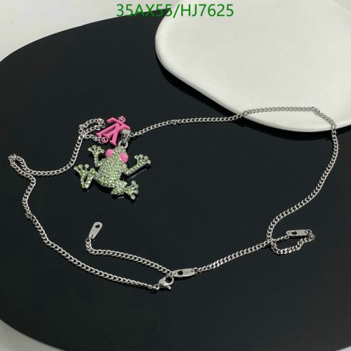 Green rhinestone frog pendant with pink bow on chain.