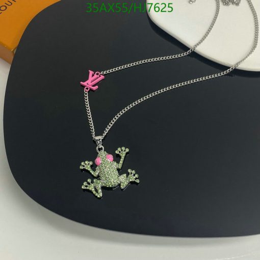 Frog pendant necklace with rhinestone details on display.