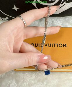 Silver chain jewelry on Louis Vuitton background.