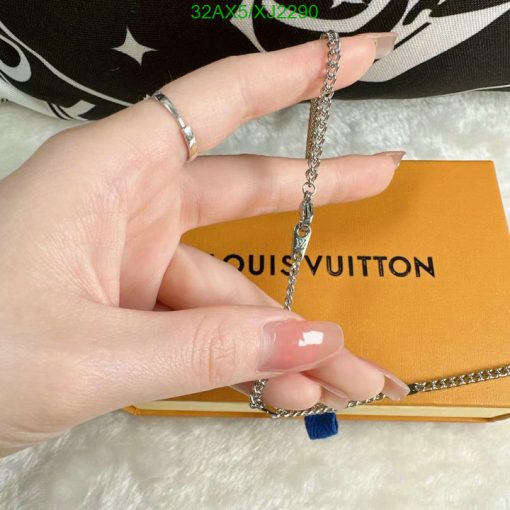 Silver chain jewelry on Louis Vuitton background.