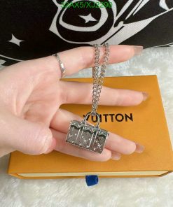 Hand displaying a designer logo pendant necklace.