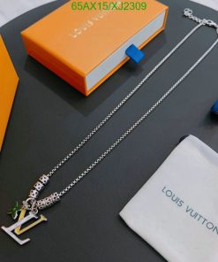 Silver designer necklace with charm and branded packaging.