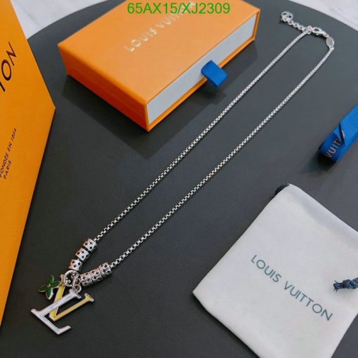 Silver designer necklace with charm and branded packaging.