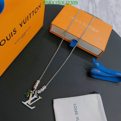 Designer necklace with luxury packaging on table.