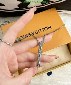 Hand displaying Louis Vuitton necklace with box.