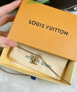 Louis Vuitton box with pendant necklace held by hand.