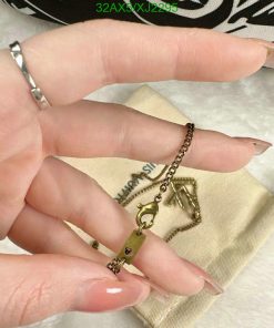 Hand holding a tiny key pendant.