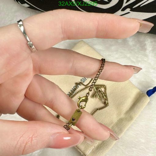 Hand holding a tiny key pendant.