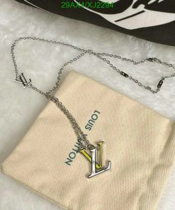 Designer logo necklace on fabric pouch.