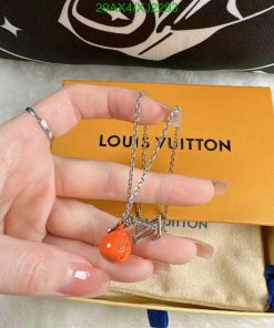 Orange charm on silver chain, Louis Vuitton box.